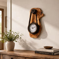Handcrafted olive wood rustic hanging timepiece clock with Roman dial on a neutral wall. | Olive Wood Rustic Hanging Timepiece Wall Clock - Olivaryn