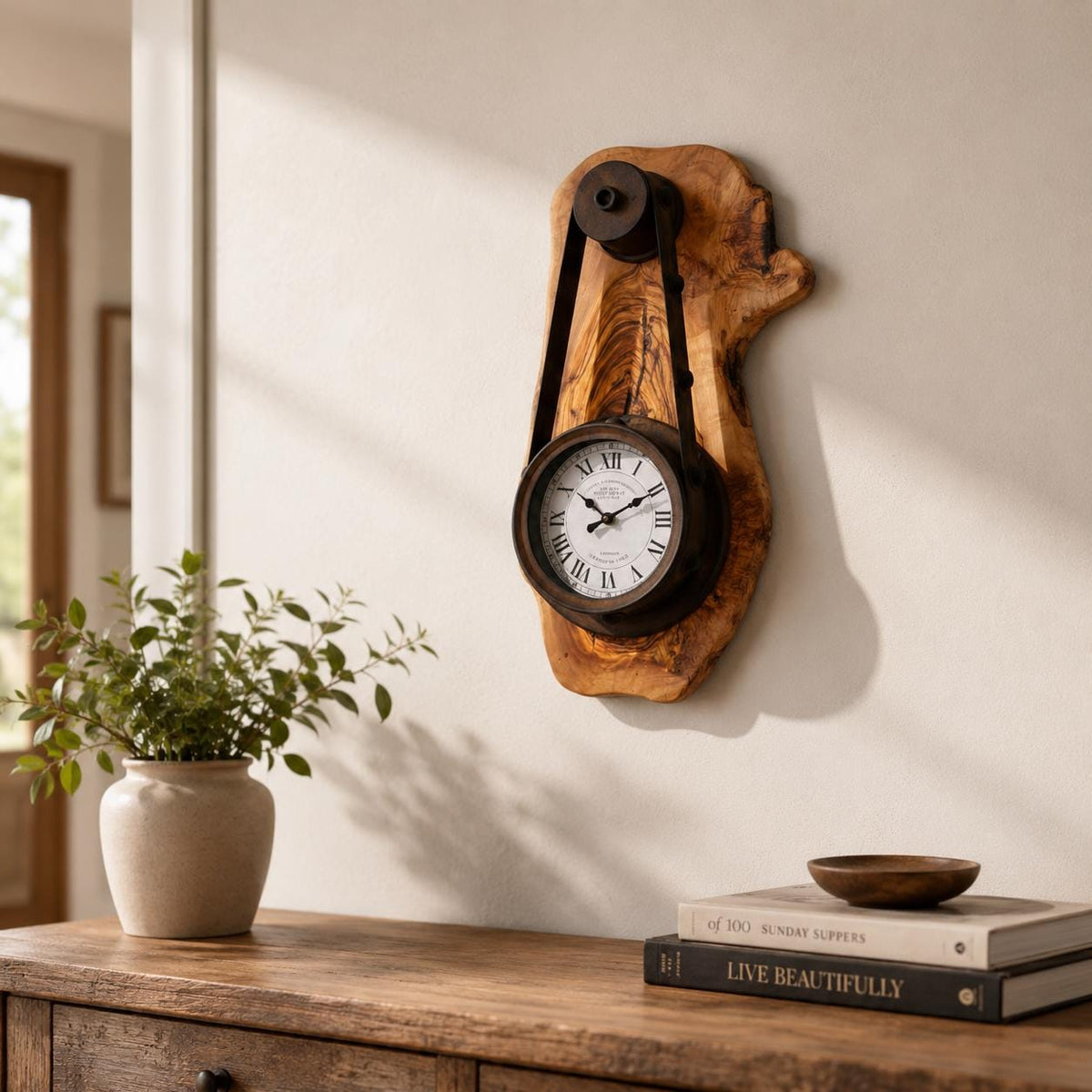 Handcrafted olive wood rustic hanging timepiece clock with Roman dial on a neutral wall. | Olive Wood Rustic Hanging Timepiece Wall Clock - Olivaryn