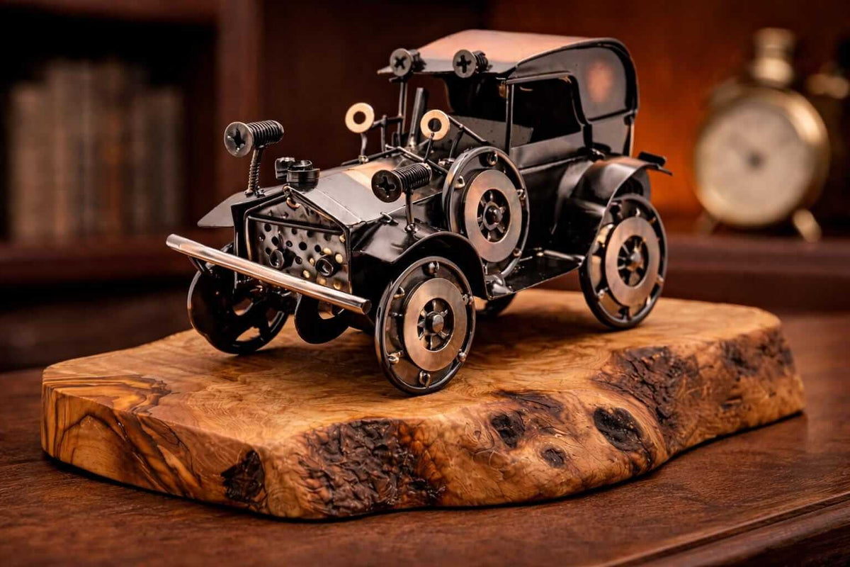 Metal vintage car olive wood sculpture displayed as an artistic accent on a rustic wooden shelf.