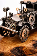 Intricate handcrafted details of a metal vintage car olive wood sculpture for desk decor.