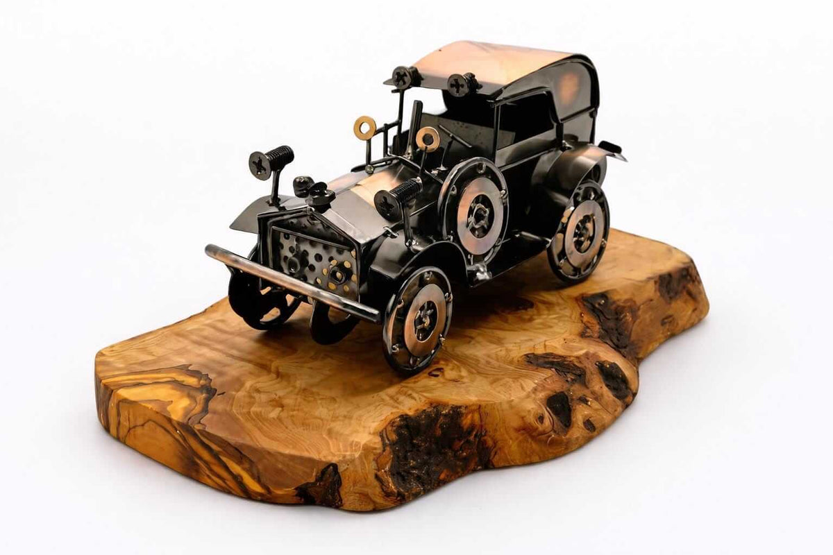 Handmade metal vintage car olive wood sculpture mounted on a rustic live edge base.
