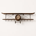 Handcrafted vintage airplane olive wood wall clock with hanging hooks on white background.