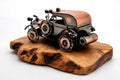 Artisan metal vintage car olive wood sculpture on a natural wooden base against white background.