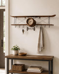 Entryway wall storage featuring a vintage airplane olive wood wall clock holding keys.