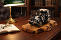 Metal vintage car olive wood sculpture displayed on an office desk under warm lamp light.