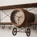 Close up of the propeller clock dial and wings on a vintage airplane olive wood wall clock.