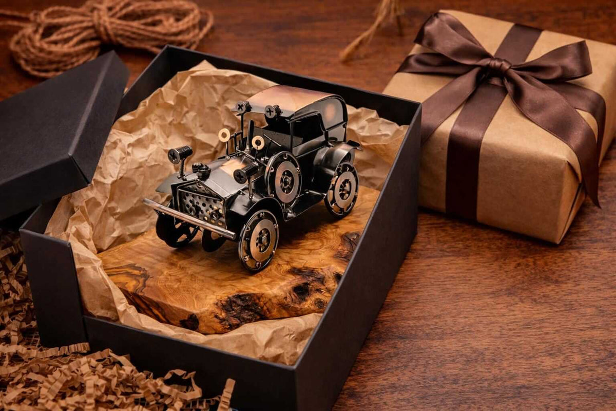 Top down view highlighting the natural wood grain of a metal vintage car olive wood sculpture base.
